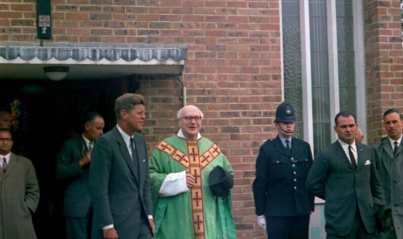 An image of President John F Kennedy outside Our Lady of the Forest with Fr Dolan